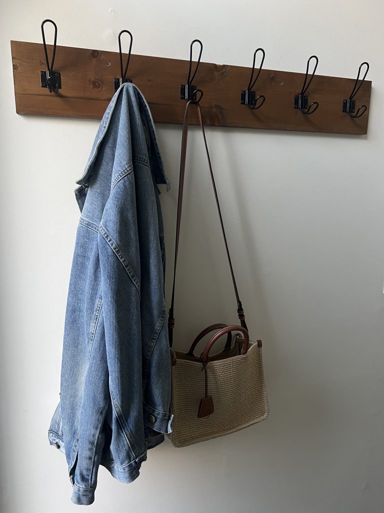 Farmhouse Coat Rack styled with a denim jacket and wicker purse